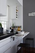 White kitchen counter with small, place-saving pull-out tables
