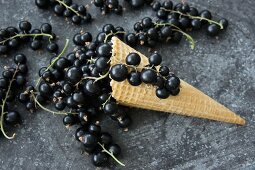 An ice cream cone with blackcurrants