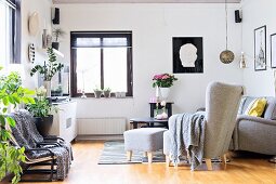 Grey leather reading chair with matching footstool in living room