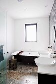 Modern, black and white bathroom with travertine floor, Oriental side table and wooden bathtub tray