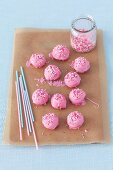Pink cake pops on a piece of baking paper