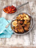 Barbecued chicken wings with baked potatoes and grilled pepper