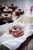Chocolate-covered doughnuts with colourful sprinkles