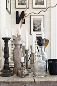 White candles in candlesticks on wooden table