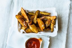 Homemade potato wedges with ketchup