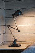 Loft Zick-Zack lamp on bedside table in corner of wood-clad room