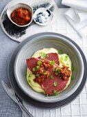 Corned beef with spicy tomato relish on parsnip puree