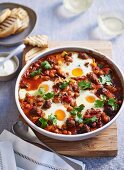 Baked eggs and lamb sausage in an oven dish