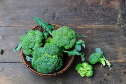 Broccoli in a bowl on a wooden surface