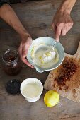 Goat's cream cheese being mixed with lemon zest