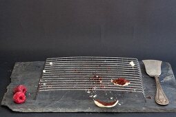 The remains of a Red Velvet cake on a wire rack