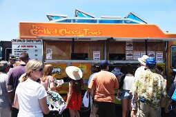 Customers in front of a food truck at a food truck festival in California, USA