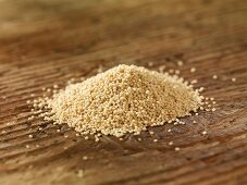 A pile of amaranth on a wooden surface