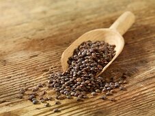 Green lentils in a wooden scoop