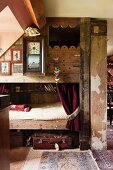 Bunk beds made from reclaimed wood and antique wall clock in vintage interior