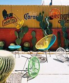 Colourful outdoor furniture against yellow corrugated metal wall with lettering