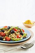 A warm vegetable salad with chickpeas, green asparagus and cherry tomatoes served with lemon breadcrumbs