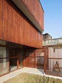 Facade of modern, Indian house with sunscreens and fences made from delicate wooden elements