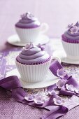 Purple cupcakes decorated with sugar flowers