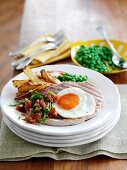Grilled ham with chips, peas and fried egg