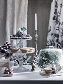 A Christmas table with mince pies, Christmas pudding and sugared grapes