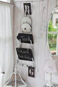 Pan lid rack holding lids and signs hung on white wooden wall