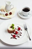 White and dark chocolate dessert with raspberries, coffee and truffle pralines