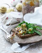 Wholemeal bread topped with pickled fish and gherkins
