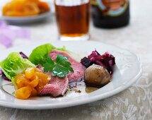 Roast beef with beetroot salad, apricots and red wine onions