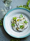 Mushroom carpaccio with olive oil and parsley