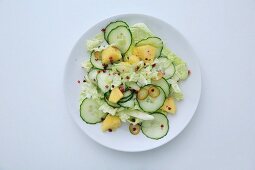 Cucumber salad with pineapple and pink pepper (top view)