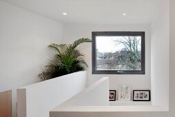 Stairwell with balustrade walls opposite window with a view