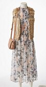 Fur waistcoat, patterned dress and leather bag on mannequin without head