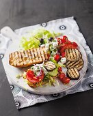 A sandwich with Greek salad ingredients and aubergines