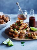 Spicy cornmeal waffles with popcorn chicken, honey and hot sauce