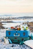 A picnic on a suitcase on a beach