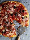 Pizza with salami, Parma ham and smoked ham