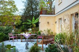 Garden furniture on terrace outside French country house