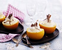 Oranges filled with orange cream garnished with chocolate curls
