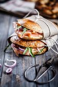 Bagels with smoked salmon, rocket and onions wrapped in paper