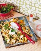 Oven-baked pumpkin and chickpea curry on a baking tray