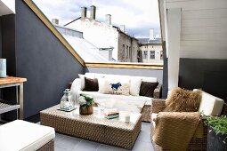 Wicker furniture in lounge area on roof terrace