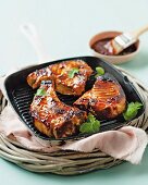 Pork chops with cranberry-barbecue sauce in a griddle pan