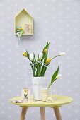 Pastel Easter arrangement; vase of tulips and lamb ornament on small table