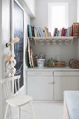 Vintage country-house-style utensils and shelf below window in former pantry