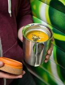 Pumpkin soup in an insulated container