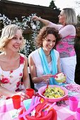 Three women having a picnic outside