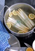 Asparagus with lemon being cooked in a pot