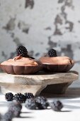 Chocolate mousse with blackberries in chocolate dishes
