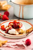 Warm Brie with glazed strawberry and raspberry salsa and pine nuts
